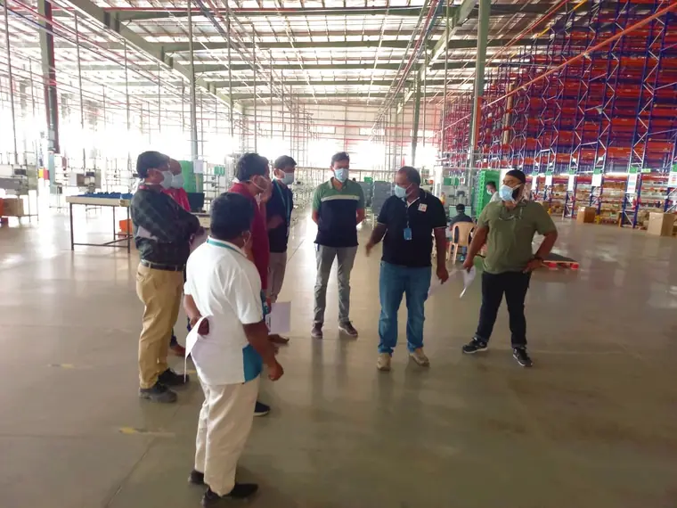 Safety walkthrough of a high-bay warehouse with racking and pallet storage